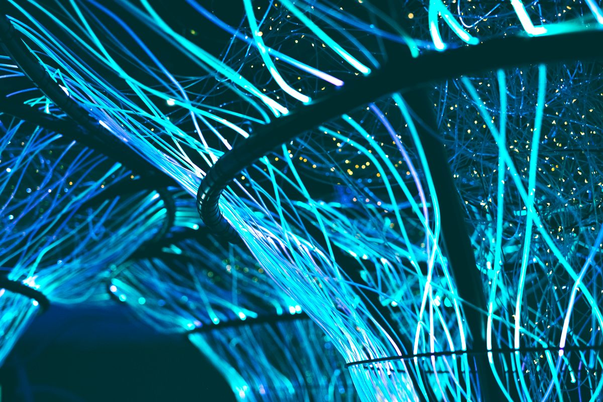Glowing blue fiber-optic cables carrying light