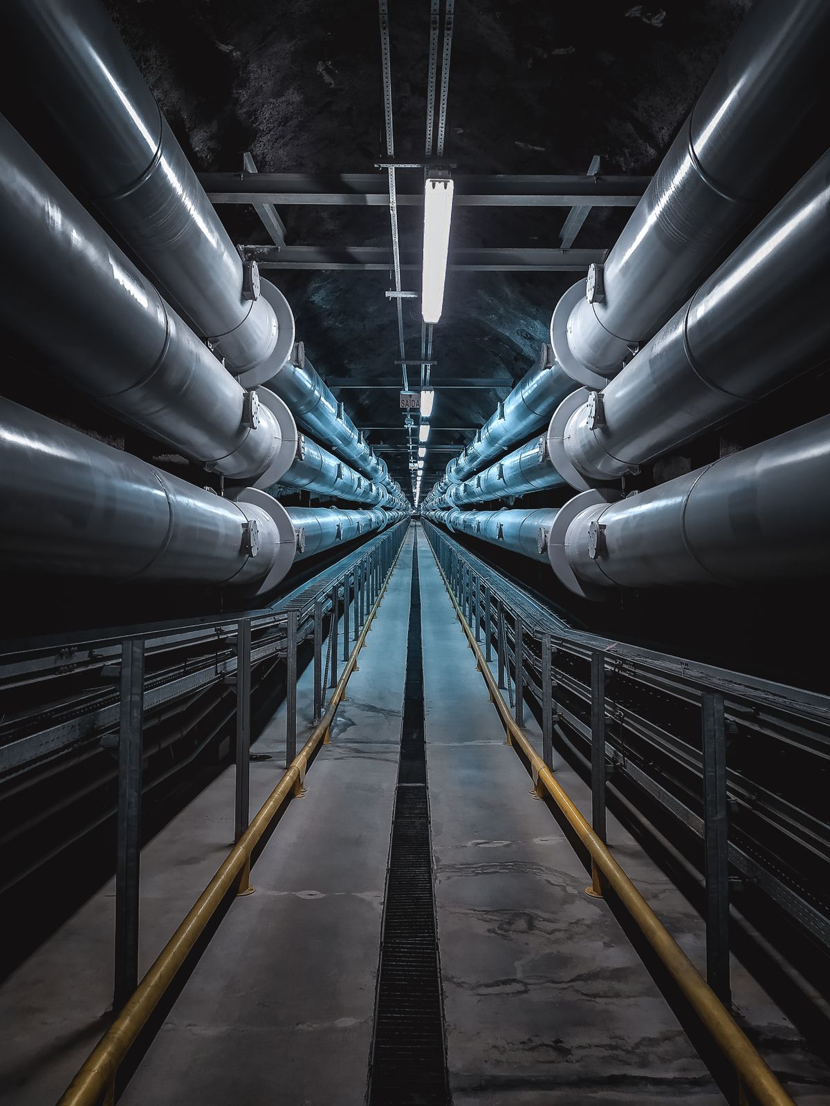 A symmetric industrial tunnel lined with steel pipes